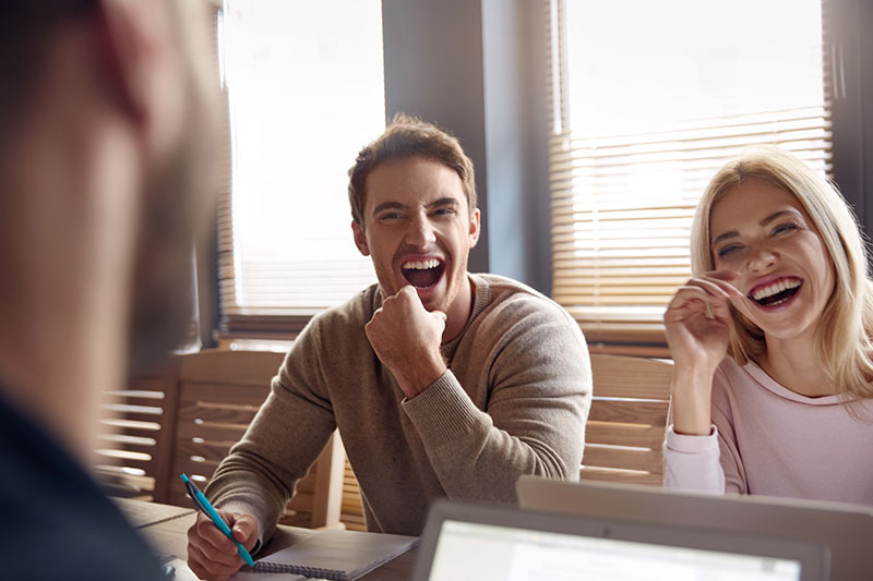 Coworkers laughing after receiving a great farewell email