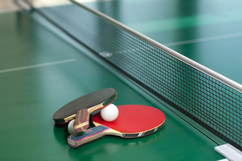 ping pong paddles on a table tennis table