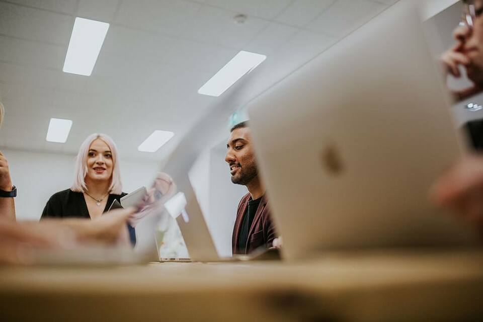 Employees supporting each other as they participate in a team meeting.