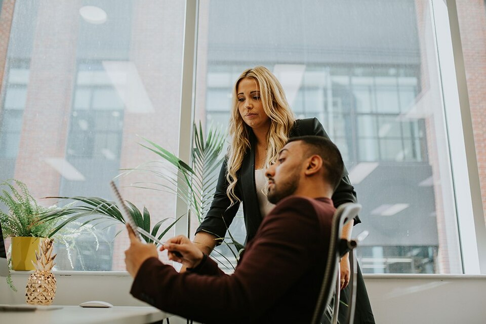 Employees looking over their paperwork together.