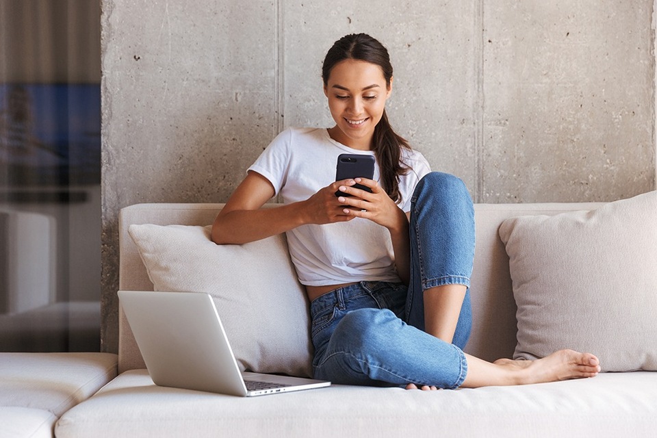 Employee working from home using her laptop and a phone