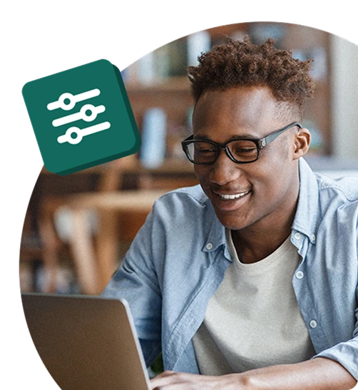 Smiling employee wearing glasses using a laptop, with a settings icon above, representing customisation or configuration in an employee rewards platform."