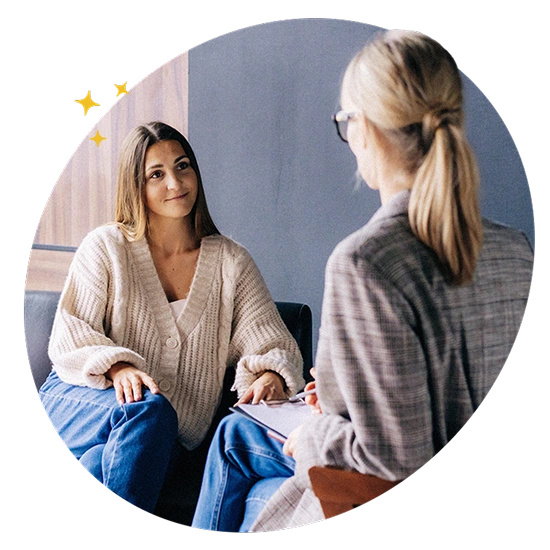 Person in a relaxed conversation with a counsellor in a private setting, representing confidential mental health and wellbeing support