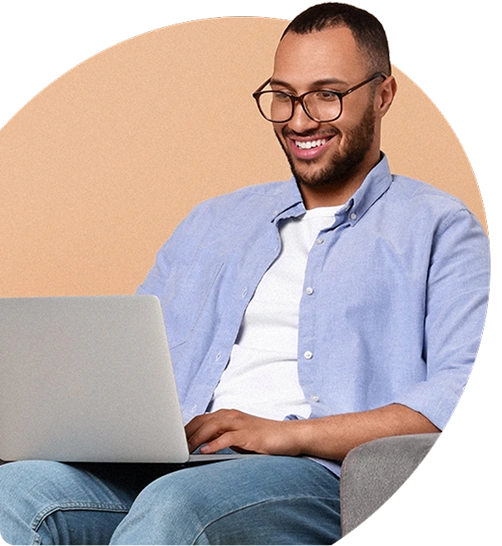 Person smiling while using a laptop, representing easy access to confidential support through an EAP