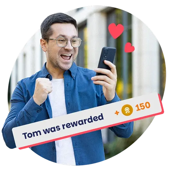A smiling employee celebrates receiving a digital reward on his phone, symbolising daily recognition and support with Perkbox.