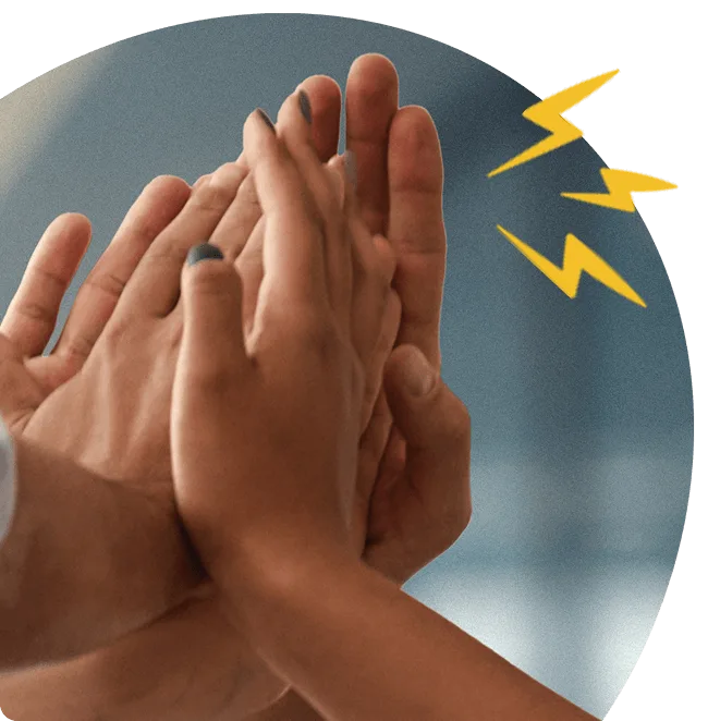 Close-up of multiple hands high-fiving, symbolising peer-to-peer recognition and team celebration.