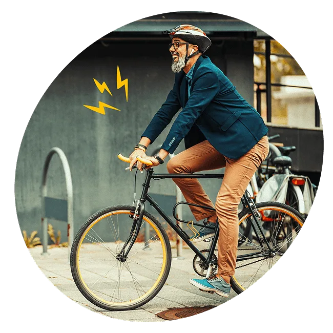 Smiling employee in business attire riding a bicycle with a helmet, symbolising a healthy and sustainable commute through the Cycle to Work scheme.