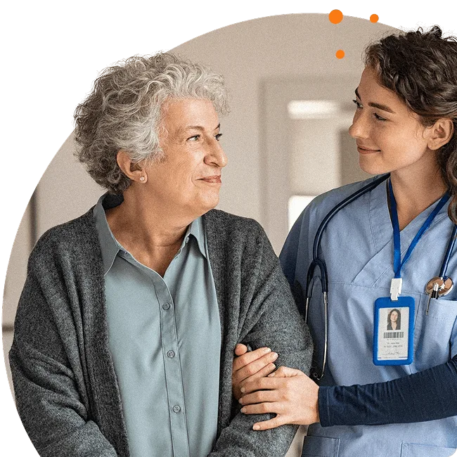 Healthcare professional offering compassionate support to an older adult, symbolising tailored employee assistance for complex issues like trauma, caregiving, and clinical intervention.
