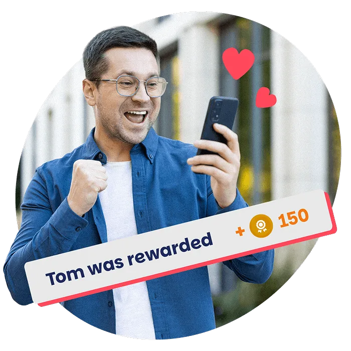 A smiling employee celebrates receiving a digital reward on his phone, symbolising daily recognition and support with Perkbox.