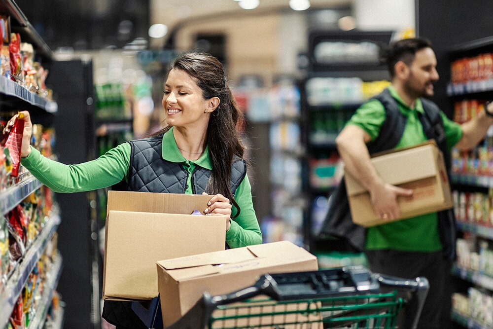 Person stacking shelves in a supermarket