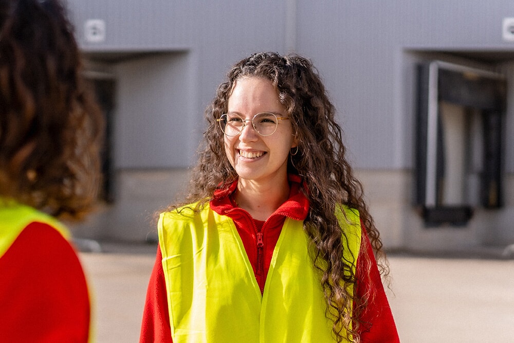 Person enjoying the sun outside of a warehouse