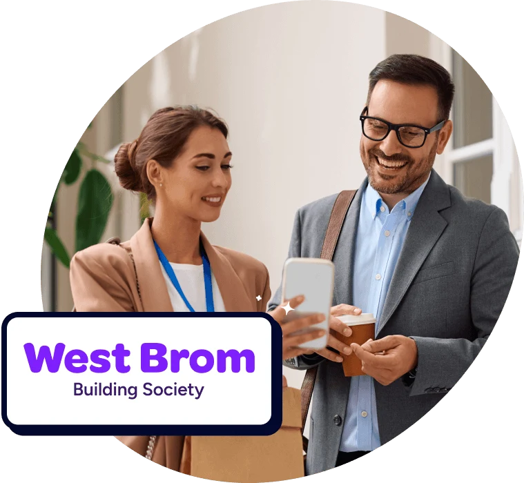 Two professionally dressed colleagues smiling while looking at a smartphone, with a West Brom Building Society logo overlay.