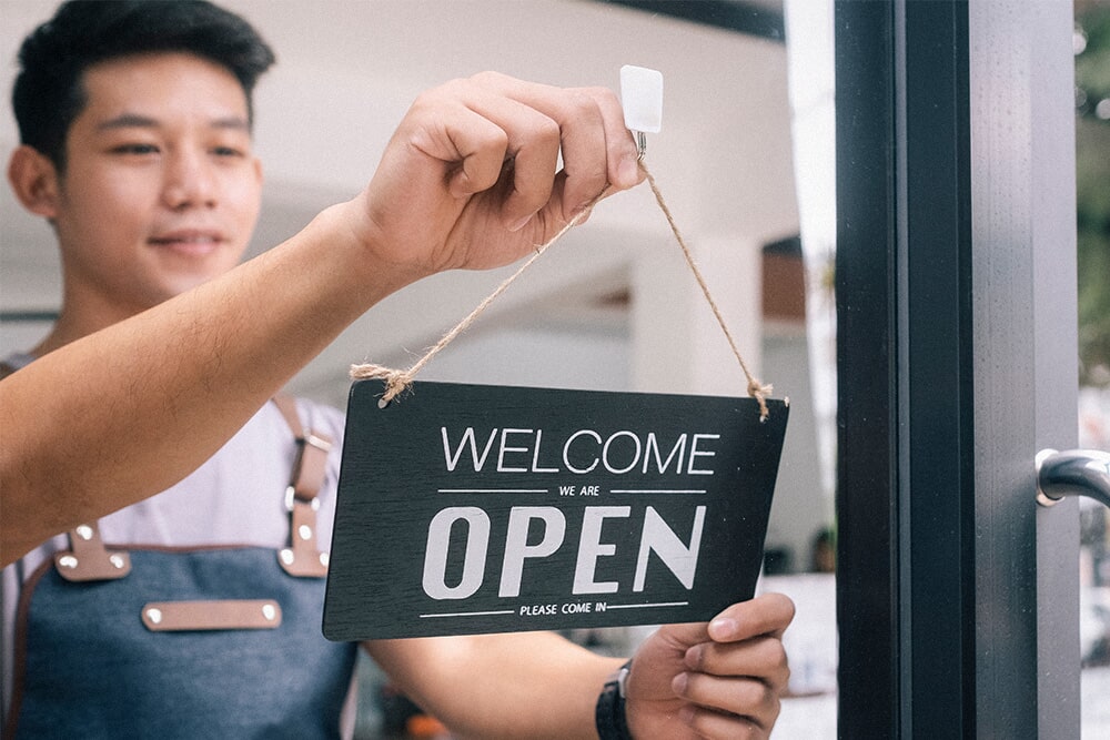 Person with opening sign