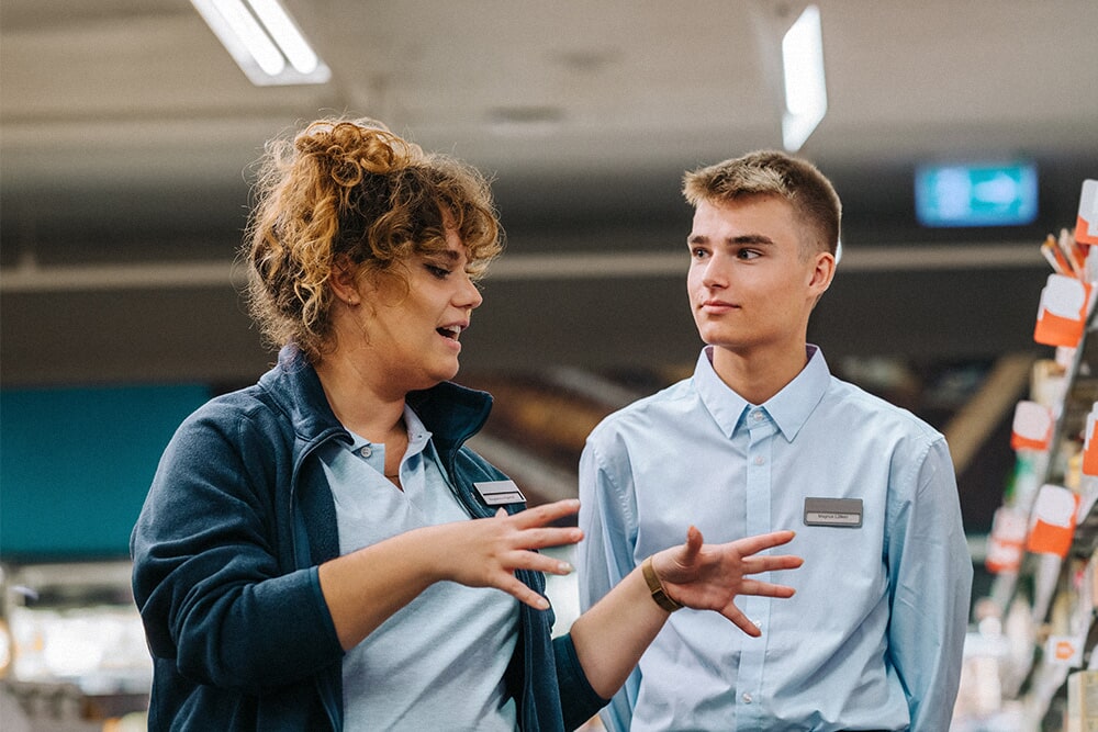 In-store manager directing staff