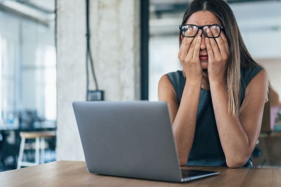 person looking tired at desk