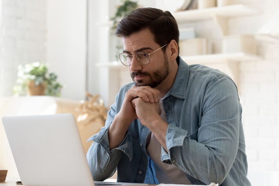 man thinking and looking at screen