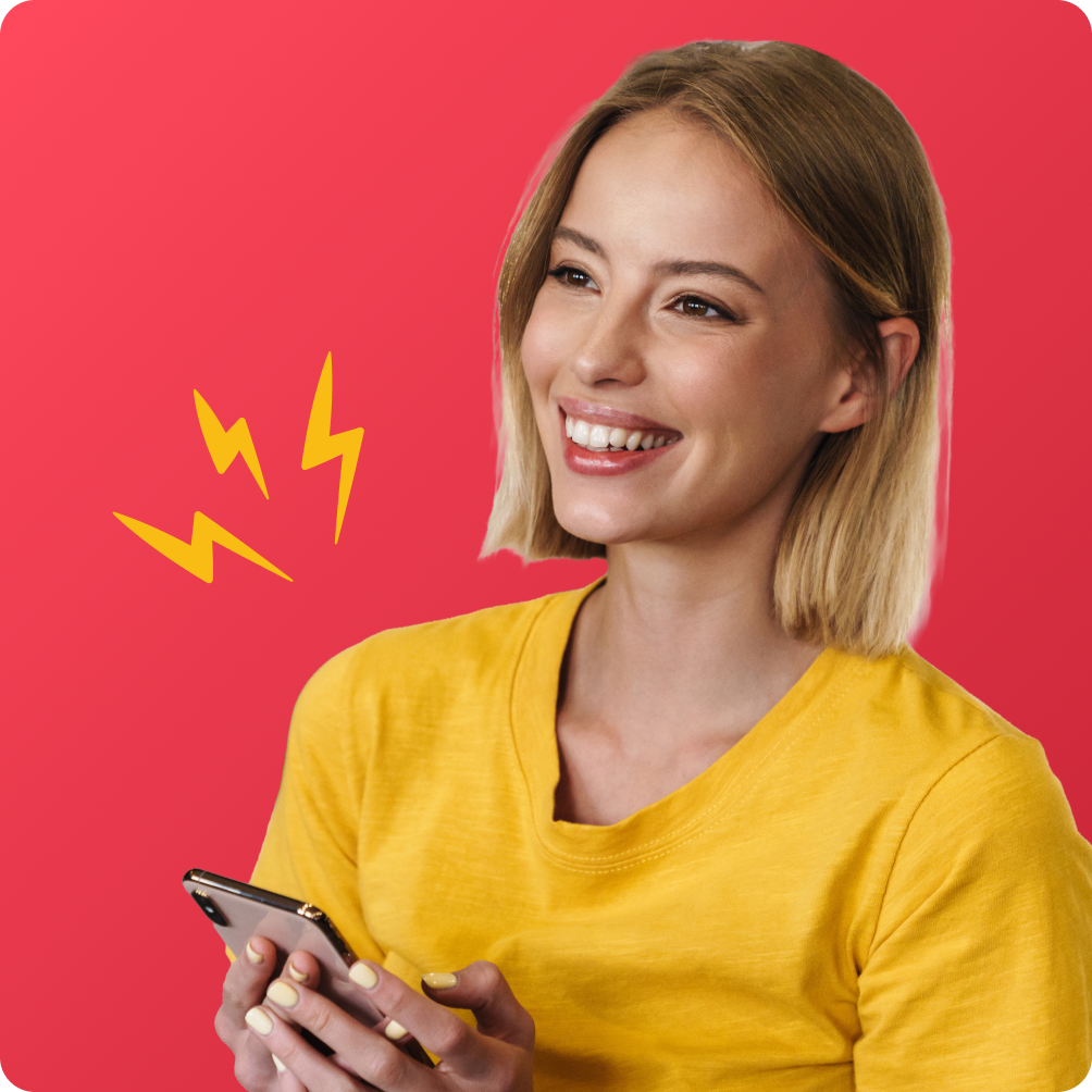 A happy employee smiles while holding a phone showing a reward notification, symbolising instant engagement through Perkbox.
