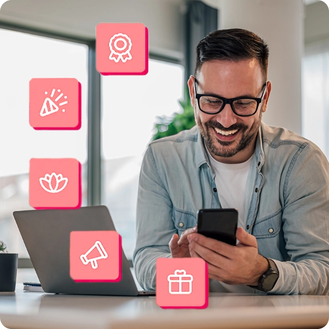 man on phone at desk with floating icons 