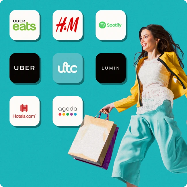 Smiling person holding shopping bags surrounded by brand logos including Uber Eats, H&M, Spotify, and Hotels.com, representing Perkbox retail and lifestyle discounts.