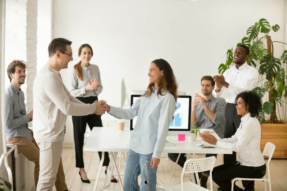 happy employees shaking hands