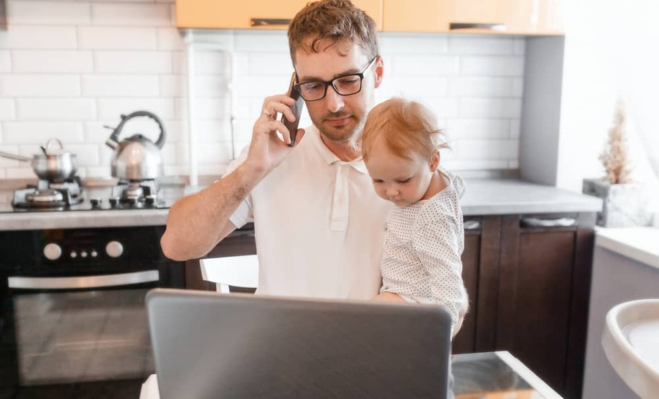 man working at home with baby